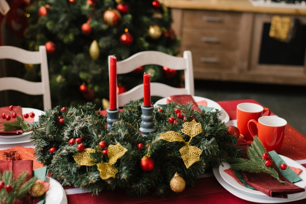 christmas-composition-with-red-candles-festive-table-with-red-tablecloth_121837-730